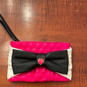 Betsey Johnson pink quilted wristlet with black bow.